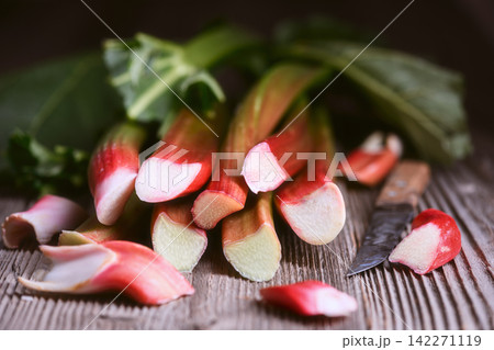 Rhubarb stalks stacked on wooden table Rhubarb stalks stacked on wooden table 142271119