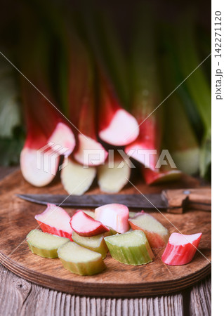 Rhubarb slices arranged in foreground with stalks behind Rhubarb slices arranged in foreground with stalks behind 142271120