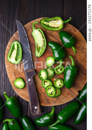 Jalapeno peppers arranged with slices and knife Jalapeno peppers arranged with slices and knife 142271178
