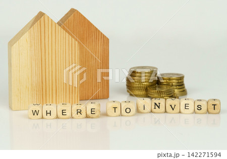 Deciding on smart investment strategies with wooden houses and coins Deciding on smart investment strategies with wooden houses and coins 142271594