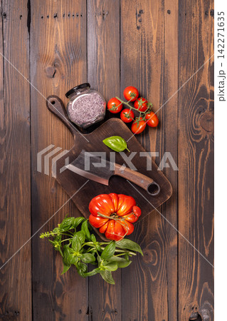 Rustic cooking ingredients with fresh tomatoes and basil 142271635