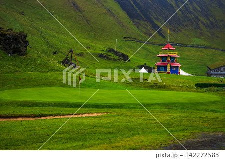 Colorful Buddhist Temple on Lush Green Golf Course in Iceland Colorful Buddhist Temple on Lush Green Golf Course in Iceland 142272583
