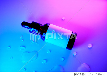 Cosmetic dropper bottle with serum and water drops Cosmetic dropper bottle with serum and water drops 142273622