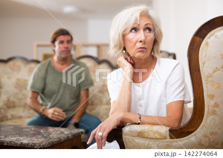 Sad family having difficulties in living room at home Sad family having difficulties in living room at home 142274064