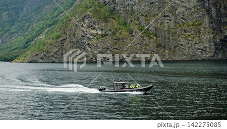 Rib boat touring norwegian fjord with passengers Rib boat touring norwegian fjord with passengers 142275085