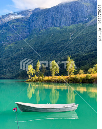 White boat floating on turquoise loen lake in stryn, norway White boat floating on turquoise loen lake in stryn, norway 142275093