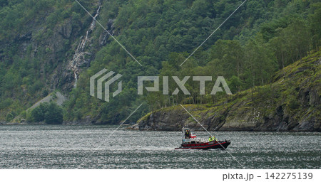Fjord landscape with rib boat touring norwegian mountains Fjord landscape with rib boat touring norwegian mountains 142275139