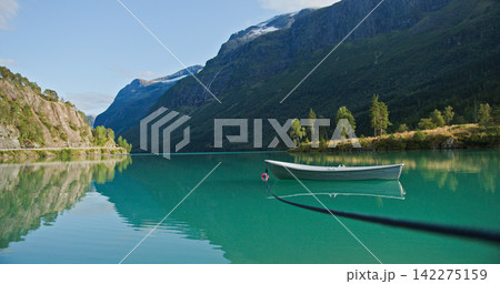 Lovatnet lake turquoise water boat reflecting mountains norway Lovatnet lake turquoise water boat reflecting mountains norway 142275159