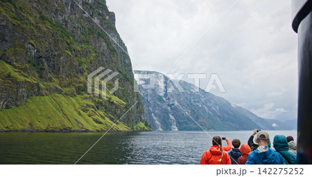 Tourists enjoying scenic nærøyfjord cruise in norway 142275252