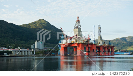 Oil rig platform anchored in a norwegian fjord Oil rig platform anchored in a norwegian fjord 142275280