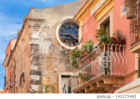 Historic Clock and Flowered Balcony in Taormina, Sicily, Italy Historic Clock and Flowered Balcony in Taormina, Sicily, Italy 142275481