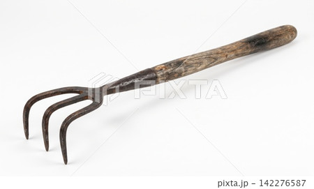 Old rusty hand cultivator gardening tool with wooden handle cultivator gardening weathered implement instrument equipment agriculture planting textured isolated background horizontal 142276587