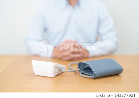 Man checking Blood pressure by Blood pressure monitor with Cuff. Systolic, SYS, Diastolic, DIA, Pulse, Hypertension, Hypotension, Heart rate, Cardiovascular Disease and May World hypertension day Man checking Blood pressure by Blood pressure monitor with Cuff. Systolic, SYS, Diastolic, DIA, Pulse, Hypertension, Hypotension, Heart rate, Cardiovascular Disease and May World hypertension day 142277921