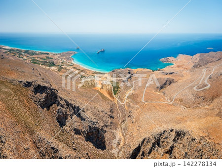 Xerokambos coastline and winding mountain road aerial view, Crete, Greece Xerokambos coastline and winding mountain road aerial view, Crete, Greece 142278134