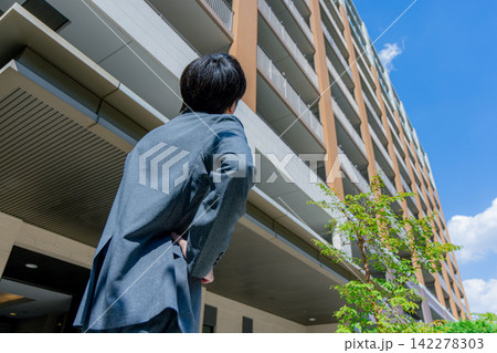 マンションを見上げるサラリーマン マンションを見上げるサラリーマン 142278303