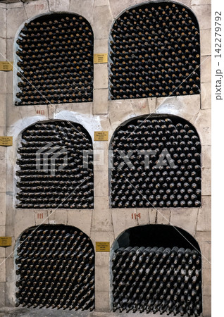 Huge bottle collection stored inside underground wine cellars tunnel Huge bottle collection stored inside underground wine cellars tunnel 142279792