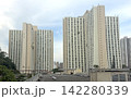Hong Kong residential apartment buildings under a cloudy sky in an urban setting Hong Kong residential apartment buildings under a cloudy sky in an urban setting 142280339