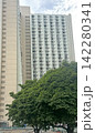 Hong Kong residential building with many windows against a cloudy sky Hong Kong residential building with many windows against a cloudy sky 142280341