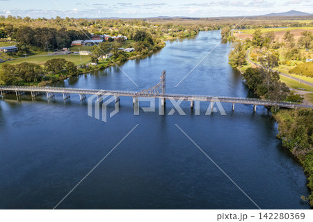 Aerial view of the bridge crossing the Clarence River at Maclean, showing the broad river, transport infrastructure and surrounding town and rural landscape in the Northern Rivers region of NSW Aerial view of the bridge crossing the Clarence River at Maclean, showing the broad river, transport infrastructure and surrounding town and rural landscape in the Northern Rivers region of NSW 142280369