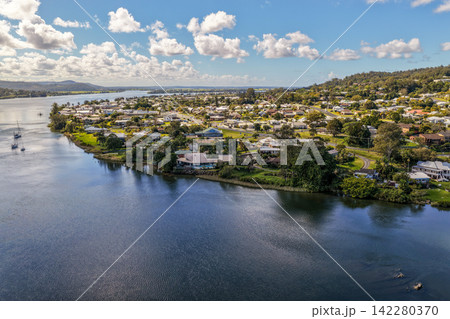 Aerial view of the town of Maclean positioned along the banks of the Clarence River, showing the township, broad waterway and surrounding green rural landscape in the Northern Rivers region of NSW Aerial view of the town of Maclean positioned along the banks of the Clarence River, showing the township, broad waterway and surrounding green rural landscape in the Northern Rivers region of NSW 142280370