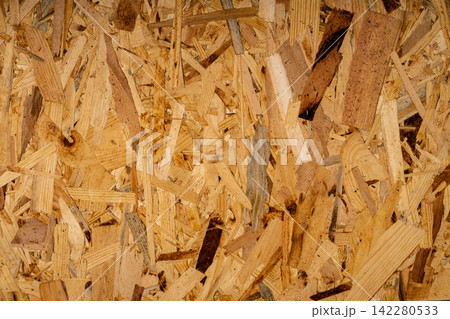 Texture of construction oriented strand board made of pressed wood chips close-up view. Texture of construction oriented strand board made of pressed wood chips close-up view. 142280533