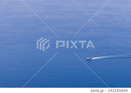 Passenger ferry, sweeping wake across open water, long downward telephoto perspective 142281604