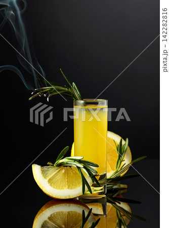 Traditional liqueur Limoncello on the black background. Traditional liqueur Limoncello on the black background. 142282816