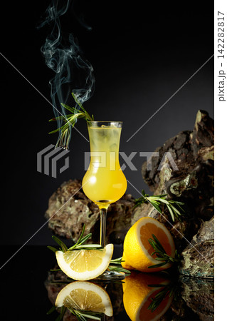 Traditional homemade lemon liqueur limoncello on the black background. 142282817