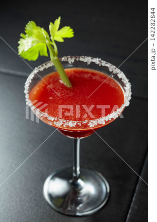 Bloody Mary cocktail with celery on a black background. Bloody Mary cocktail with celery on a black background. 142282844