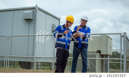 Two Asian Male Electrical Engineers Inspecting Outdoor Power Substation Two Asian Male Electrical Engineers Inspecting Outdoor Power Substation 142283167