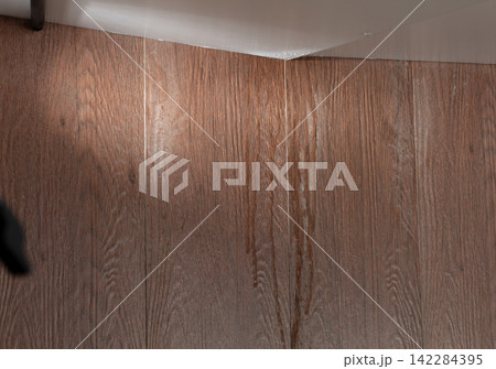 Heavy storm rain create water flow from edge of ceiling and dirty stain on wall. Water leaking from top ceiling as droplets and flow in old house Heavy storm rain create water flow from edge of ceiling and dirty stain on wall. Water leaking from top ceiling as droplets and flow in old house 142284395