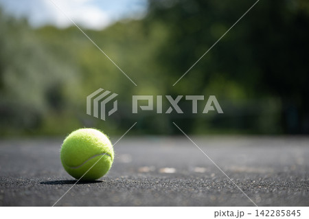 Tennis ball on outdoor court with copy space 142285845