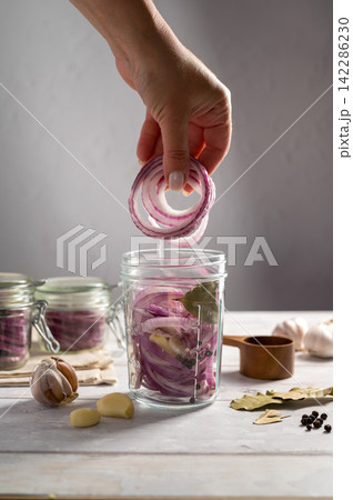 Homemade pickled red onions in jars, bright background Homemade pickled red onions in jars, bright background 142286230