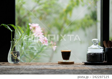 Coffee glass cup and coffee beans in a glass vase Coffee glass cup and coffee beans in a glass vase 142287125