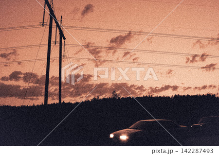 Cinematic vintage illustration of car with headlights on under sunset sky and power lines 142287493