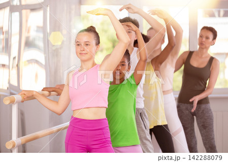 Teen girl mastering battement tendu at barre at ballet class Teen girl mastering battement tendu at barre at ballet class 142288079