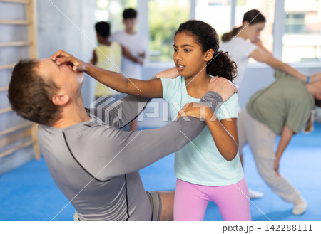 Self-defense training - girl delivers painful blow to the eyes of male trainer Self-defense training - girl delivers painful blow to the eyes of male trainer 142288111