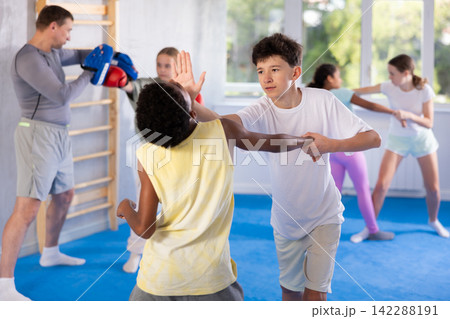 Two boys practicing self-defense techniques Two boys practicing self-defense techniques 142288191