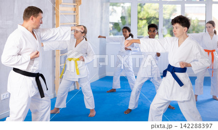 Group of children train karate techniques 142288397
