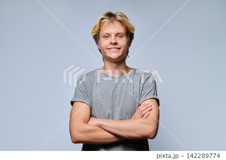 Portrait of confident smiling teenage boy with crossed arms Portrait of confident smiling teenage boy with crossed arms 142289774