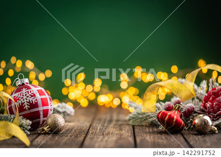 Red Plaid Christmas Ornament with Gold Ribbon on Rustic Wood Red Plaid Christmas Ornament with Gold Ribbon on Rustic Wood 142291752