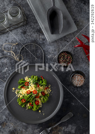 Delicious gourmet dish of roasted broccoli and couscous seasoned with chili pepper 142292619