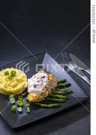 Green asparagus with grilled chicken fillet and couscous Green asparagus with grilled chicken fillet and couscous 142292931