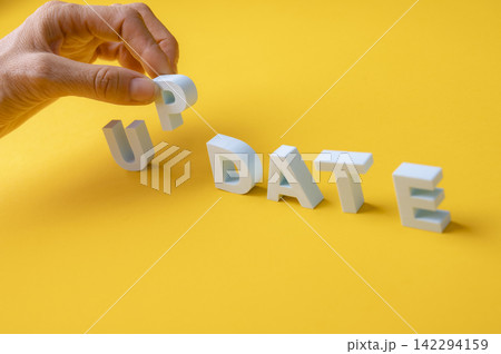 Update and upgrade concept with hand completing the UPDATE word Update and upgrade concept with hand completing the UPDATE word 142294159