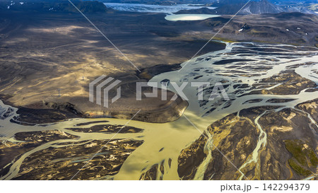 Aerial view of glacial river delta with braided channels, ytra Iceland Aerial view of glacial river delta with braided channels, ytra Iceland 142294379