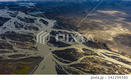 Aerial view of braided glacial river delta with sediment plumes, ytra Iceland 142294380