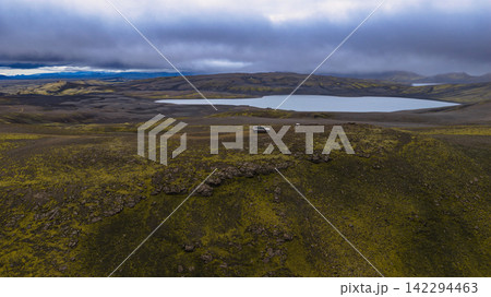 Aerial view of moss-covered lava field with glacial lake Aerial view of moss-covered lava field with glacial lake 142294463