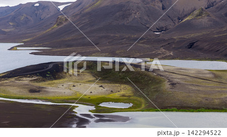 Aerial view of volcanic terrain with glacial lakes and lava fields, Iceland Aerial view of volcanic terrain with glacial lakes and lava fields, Iceland 142294522