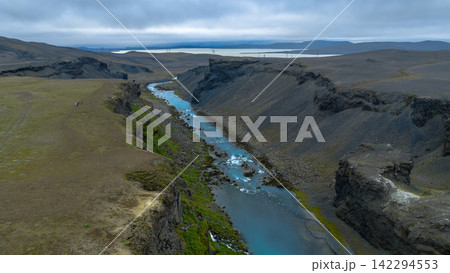 Aerial view of glacial river canyon with turquoise water and volcanic terrain, Rang?r?ing ytra Iceland Aerial view of glacial river canyon with turquoise water and volcanic terrain, Rang?r?ing ytra Iceland 142294553
