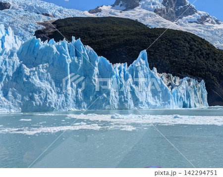 Blue Glacier Terminus With Forested Ridge and Mountain Ice Blue Glacier Terminus With Forested Ridge and Mountain Ice 142294751